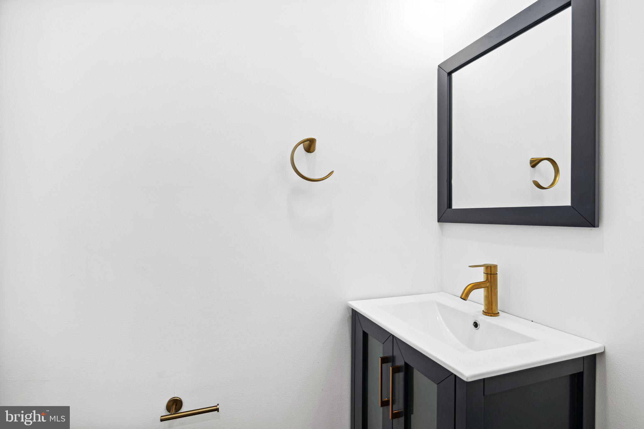 1319 North 28th Street Philadelphia, PA 19121 - Photo 9 of 9 a bathroom with a sink and mirror