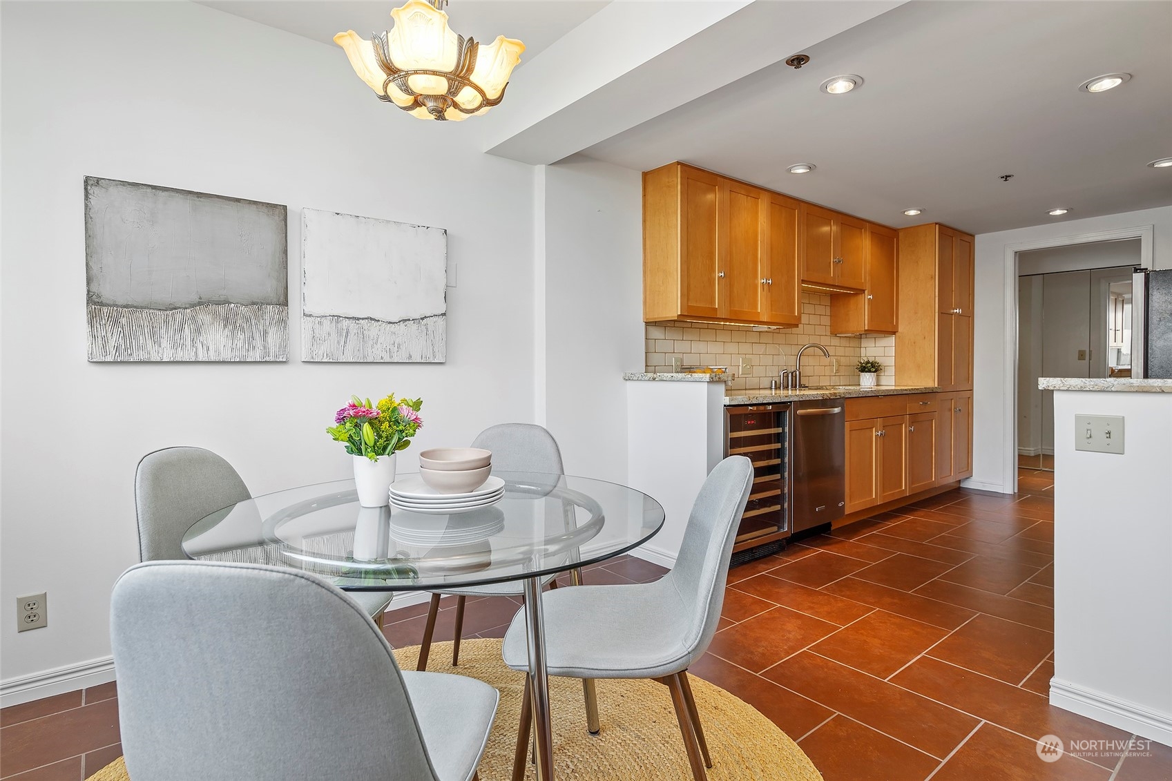 1120 Spring Street, Unit 401 Seattle, WA 98104 - Photo 13 of 34 a view of a dining room with furniture and a chandelier