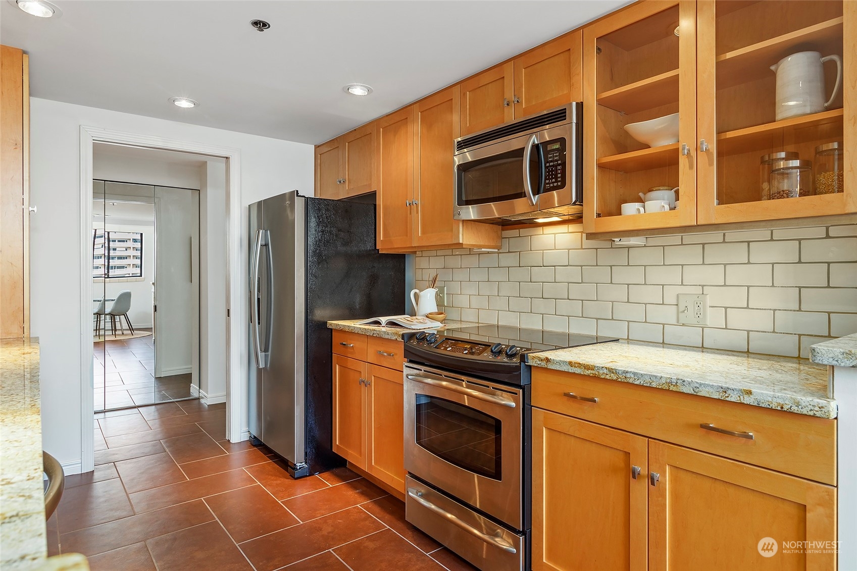 1120 Spring Street, Unit 401 Seattle, WA 98104 - Photo 15 of 34 a kitchen with stainless steel appliances granite countertop a refrigerator and a stove