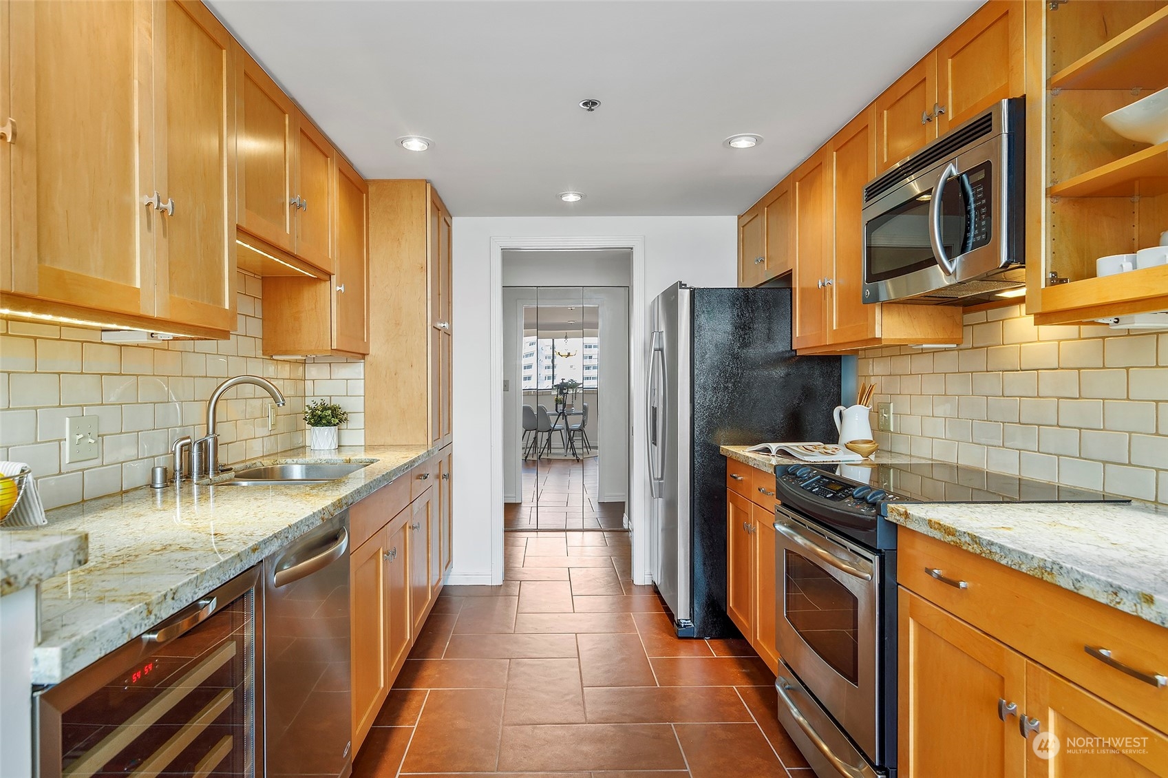 1120 Spring Street, Unit 401 Seattle, WA 98104 - Photo 16 of 34 a kitchen with stainless steel appliances granite countertop a sink stove and refrigerator
