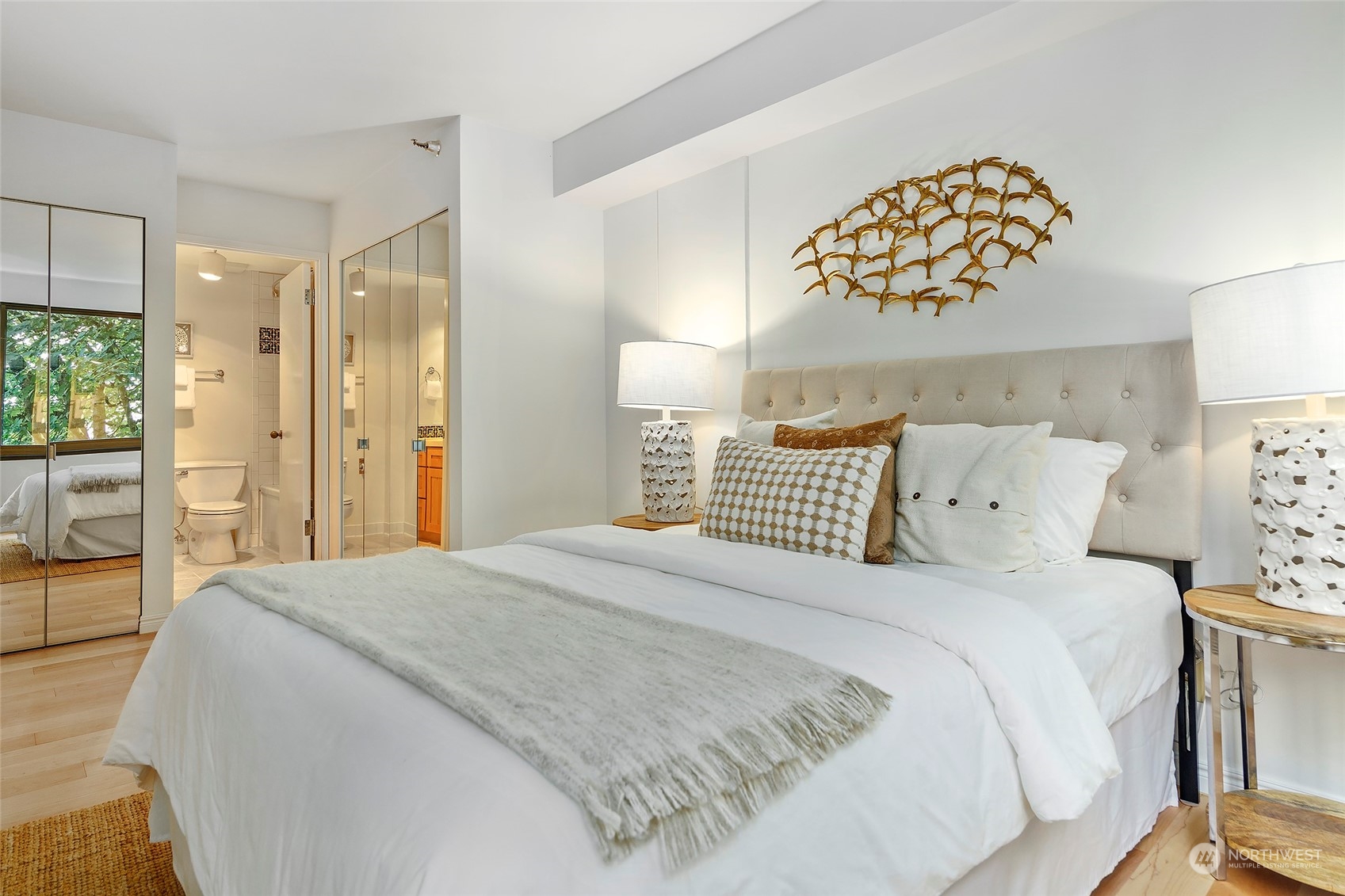 1120 Spring Street, Unit 401 Seattle, WA 98104 - Photo 17 of 34 a bedroom with a bed and a chandelier