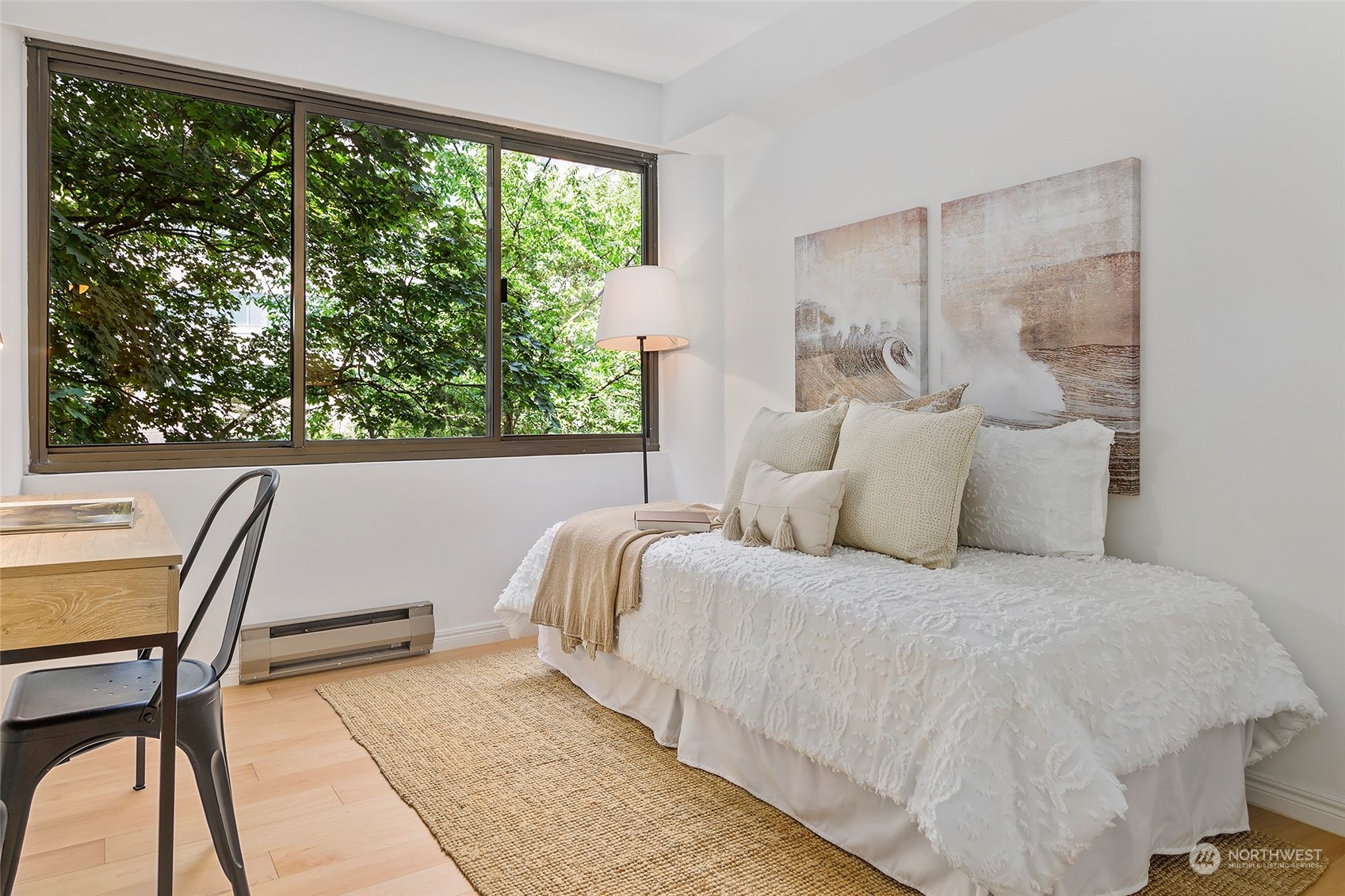 1120 Spring Street, Unit 401 Seattle, WA 98104 - Photo 20 of 34 a bedroom with a bed a large window with table and chair