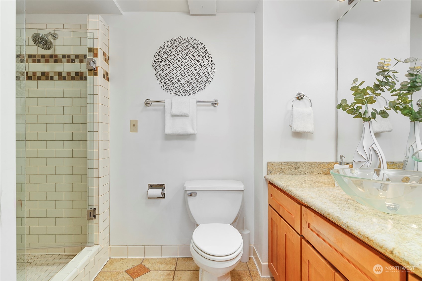 1120 Spring Street, Unit 401 Seattle, WA 98104 - Photo 21 of 34 a bathroom with a granite countertop sink a toilet and shower