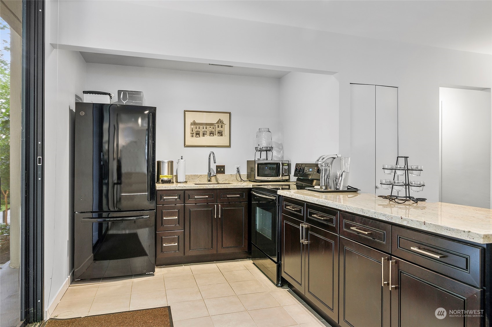1120 Spring Street, Unit 401 Seattle, WA 98104 - Photo 26 of 34 a kitchen with a sink and refrigerator