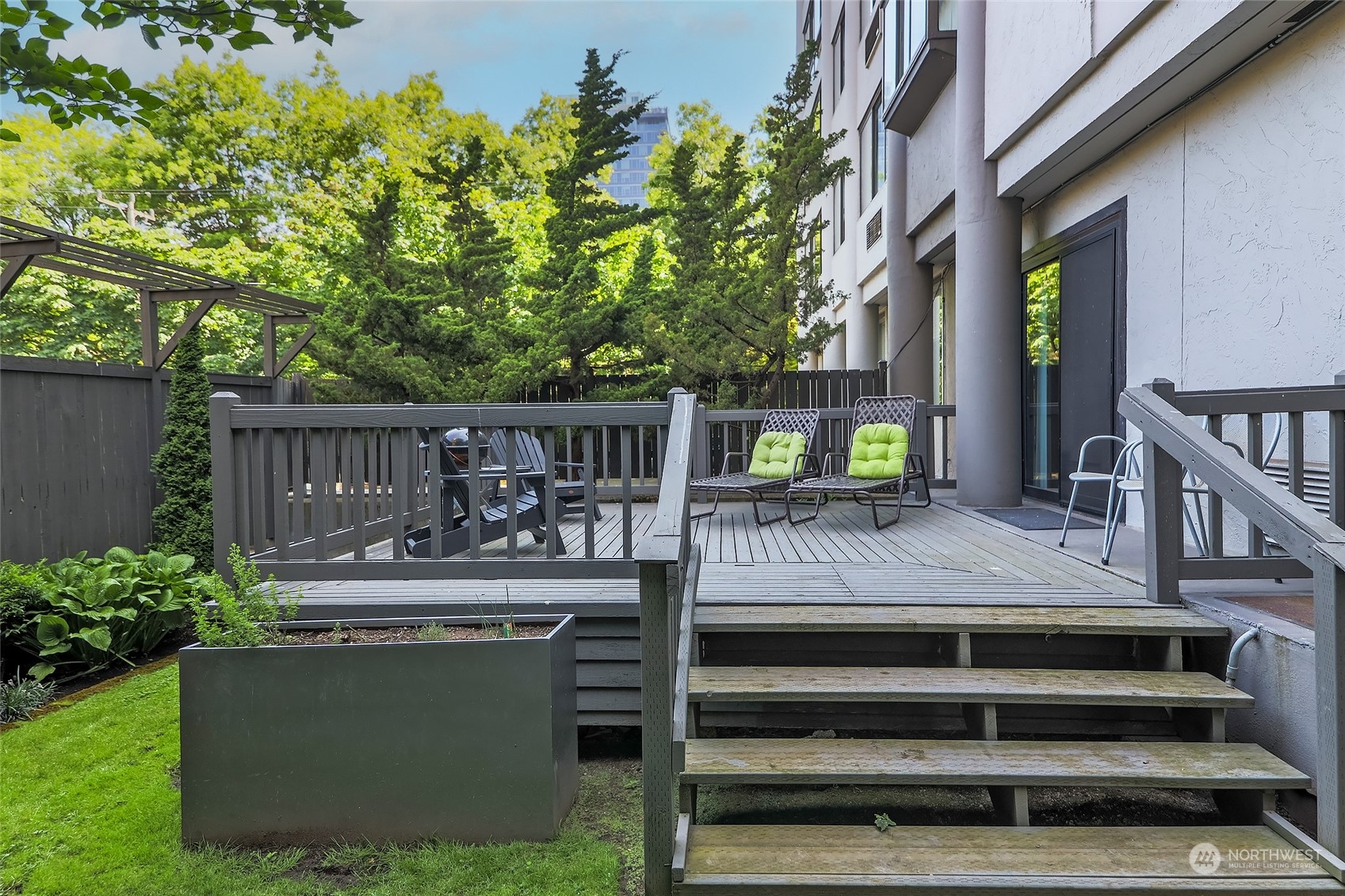 1120 Spring Street, Unit 401 Seattle, WA 98104 - Photo 32 of 34 a view of house with backyard outdoor seating and hardwood
