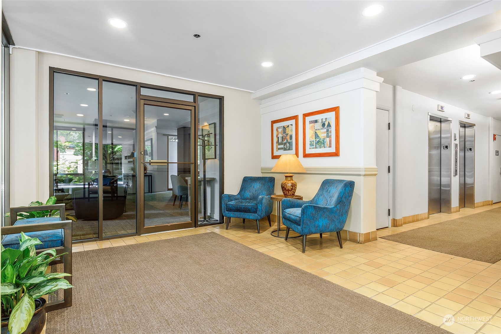 1120 Spring Street, Unit 401 Seattle, WA 98104 - Photo 7 of 34 a living room with furniture and a potted plant