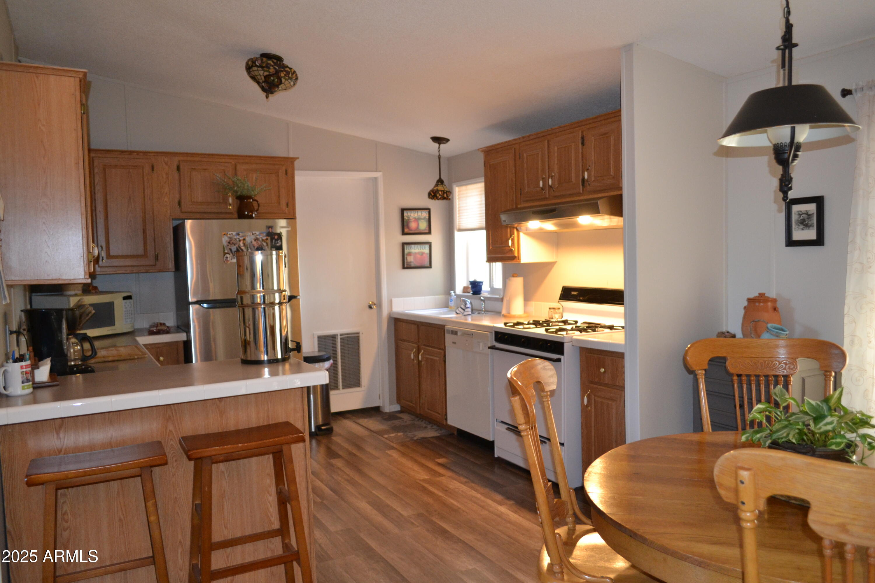 656 Sundown Drive Snowflake, AZ 85937 - Photo 2 of 29 a kitchen with refrigerator cabinets and wooden floor