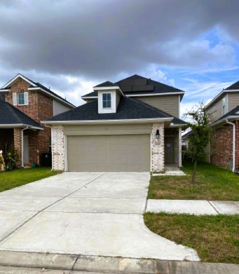 9210 Wood Beach Way Houston, TX 77034 - Photo 2 of 17 a front view of a house with a yard and garage