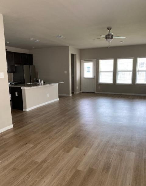 9210 Wood Beach Way Houston, TX 77034 - Photo 7 of 17 a view of a living room and kitchen with furniture wooden floor and windows