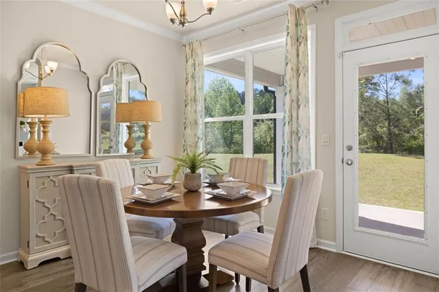 a living room with fireplace furniture and a large window