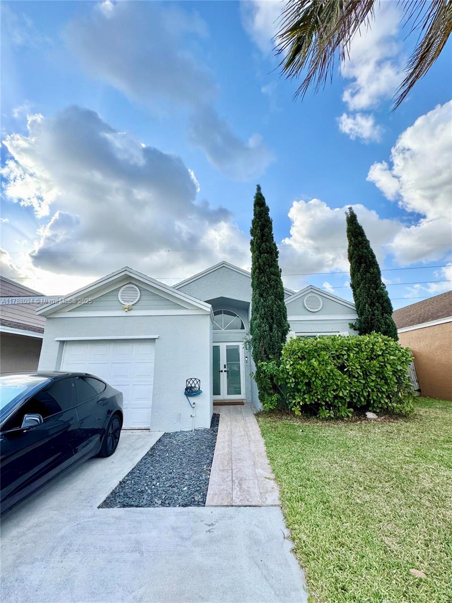 a front view of a house with garden