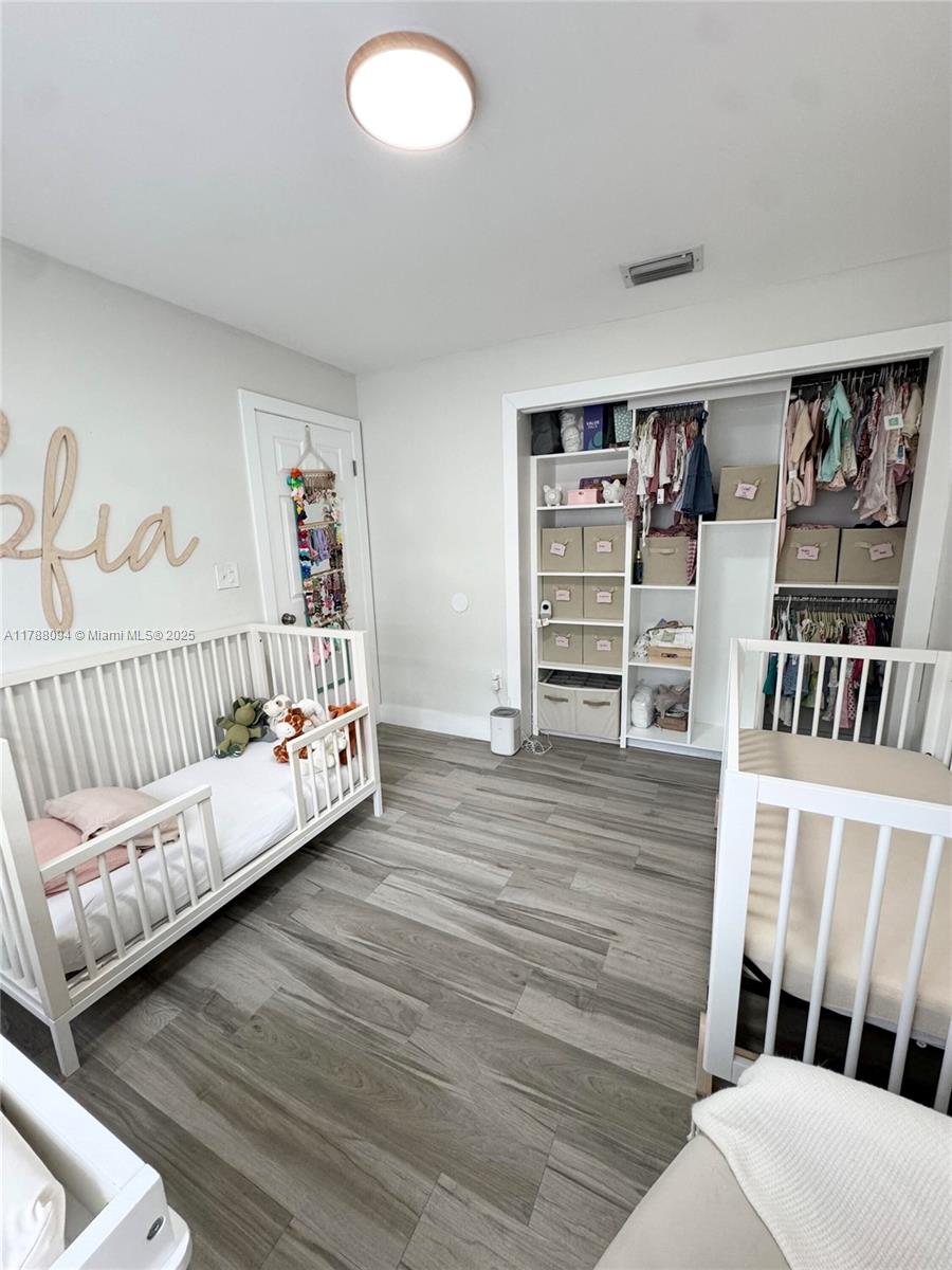 14626 Southwest 128th Court Road Miami, FL 33186 - Photo 11 of 41 a bedroom with furniture and a book shelf