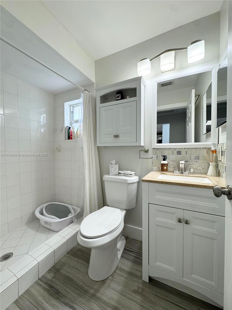 14626 Southwest 128th Court Road Miami, FL 33186 - Photo 12 of 41 a bathroom with a toilet a sink and mirror