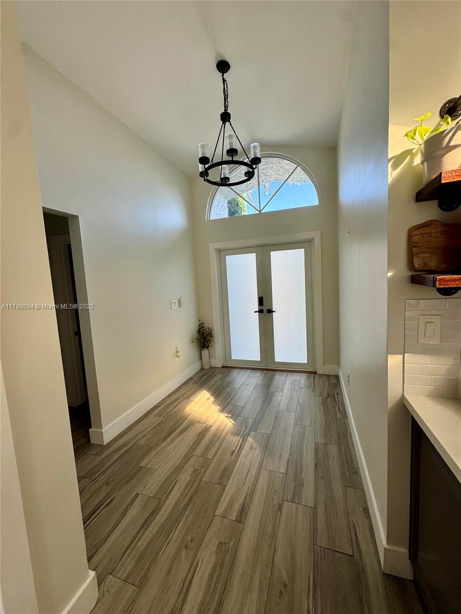 14626 Southwest 128th Court Road Miami, FL 33186 - Photo 14 of 41 a view of a room with wooden floor and staircase