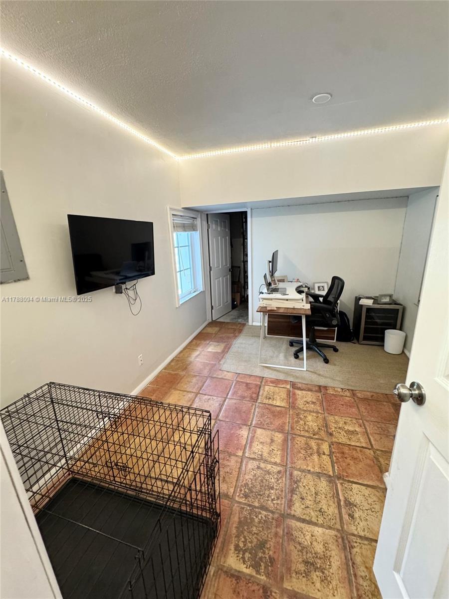 14626 Southwest 128th Court Road Miami, FL 33186 - Photo 20 of 41 a living room with a couch and a flat screen tv