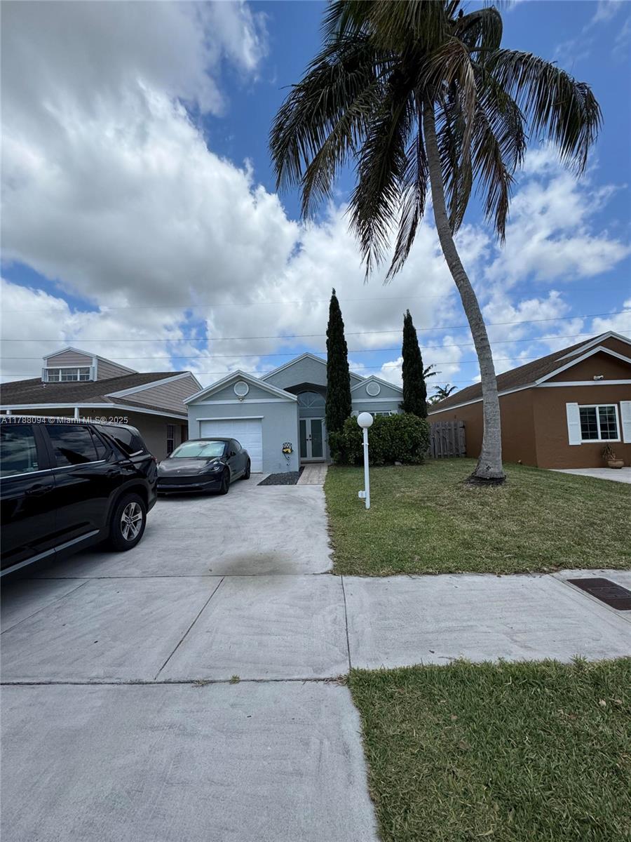 14626 Southwest 128th Court Road Miami, FL 33186 - Photo 2 of 41 a view of a yard and front view of a house