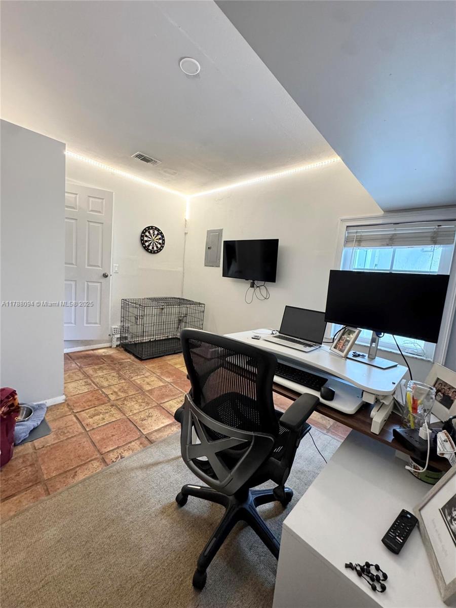 14626 Southwest 128th Court Road Miami, FL 33186 - Photo 21 of 41 a workspace with furniture and a flat screen tv