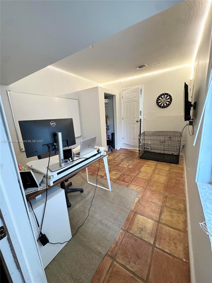 14626 Southwest 128th Court Road Miami, FL 33186 - Photo 22 of 41 a living room with a gaming machine and a table