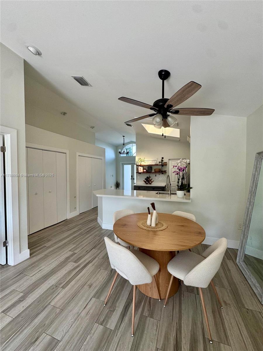 14626 Southwest 128th Court Road Miami, FL 33186 - Photo 23 of 41 a view of a dining room with furniture and wooden floor