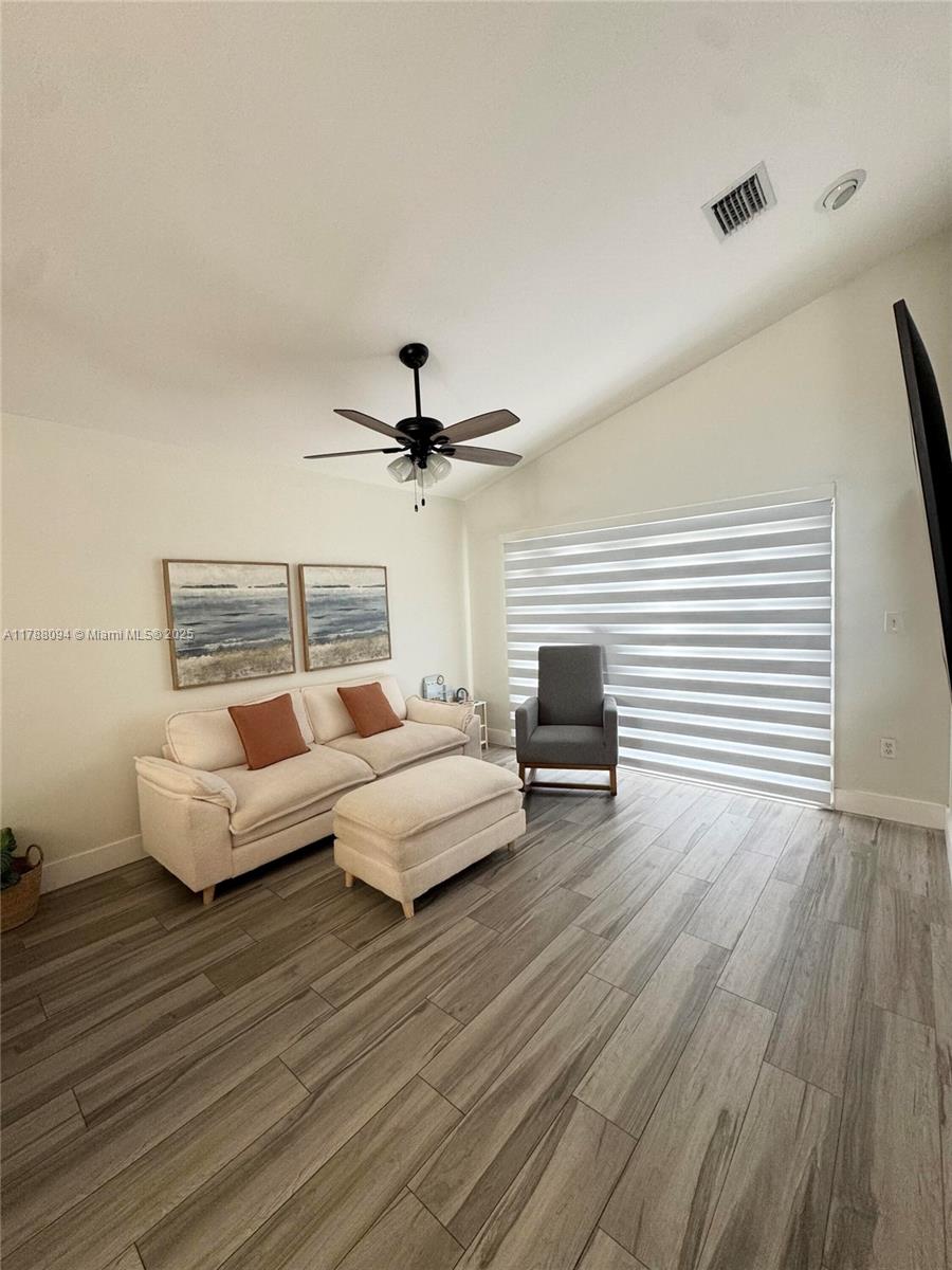 14626 Southwest 128th Court Road Miami, FL 33186 - Photo 26 of 41 a living room with furniture and a wooden floor