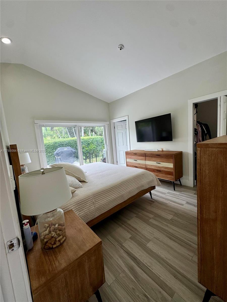 14626 Southwest 128th Court Road Miami, FL 33186 - Photo 28 of 41 a bedroom with a bed and wooden floor