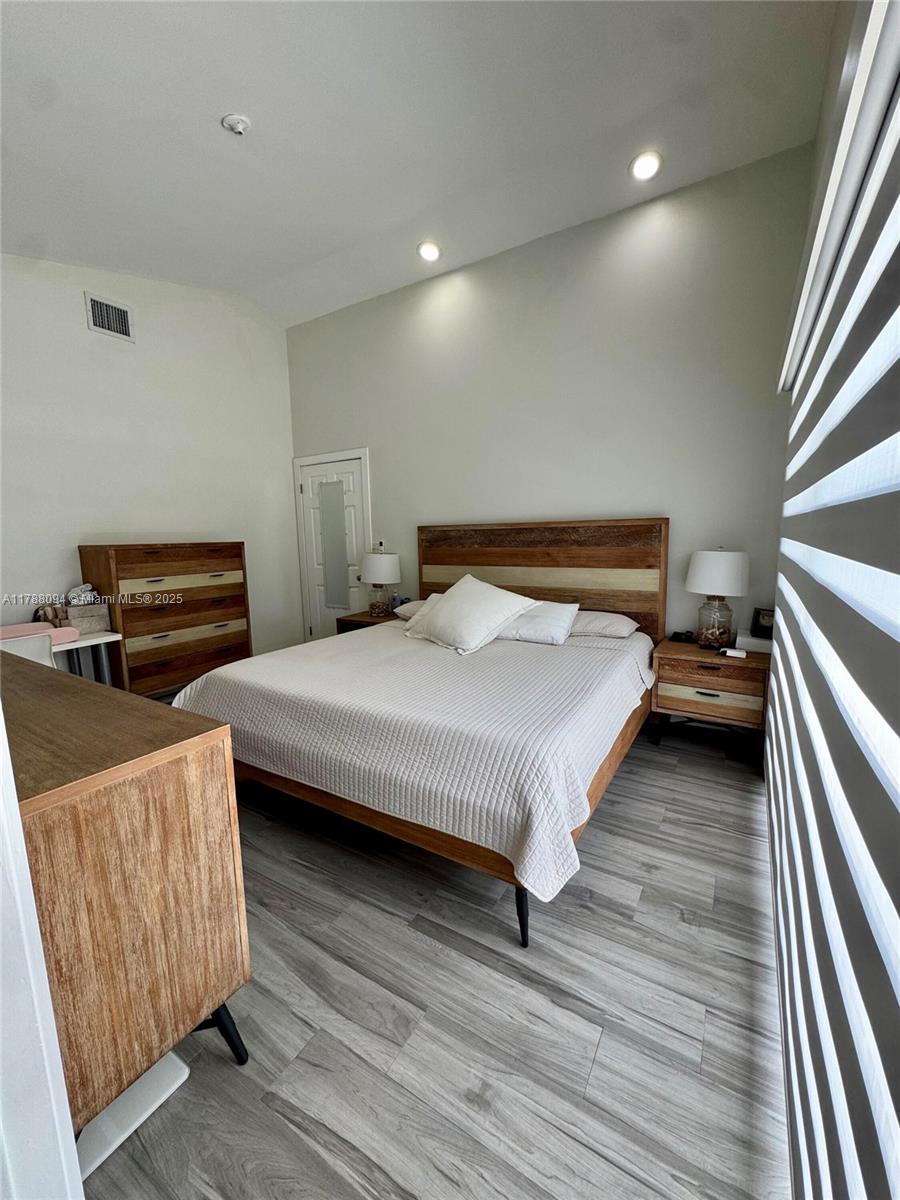 14626 Southwest 128th Court Road Miami, FL 33186 - Photo 29 of 41 a bedroom with a bed and furniture