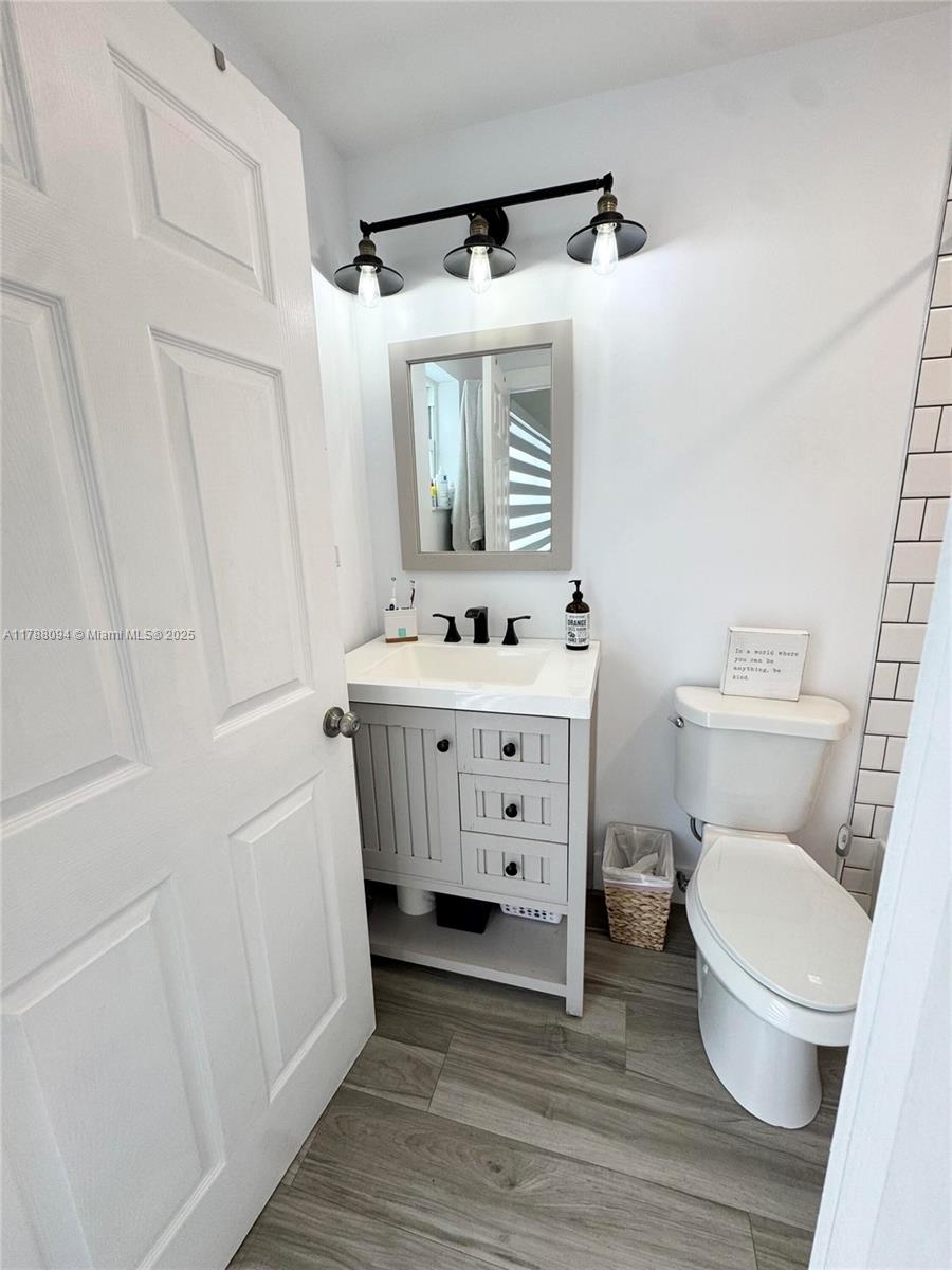 14626 Southwest 128th Court Road Miami, FL 33186 - Photo 31 of 41 a bathroom with a sink toilet and mirror