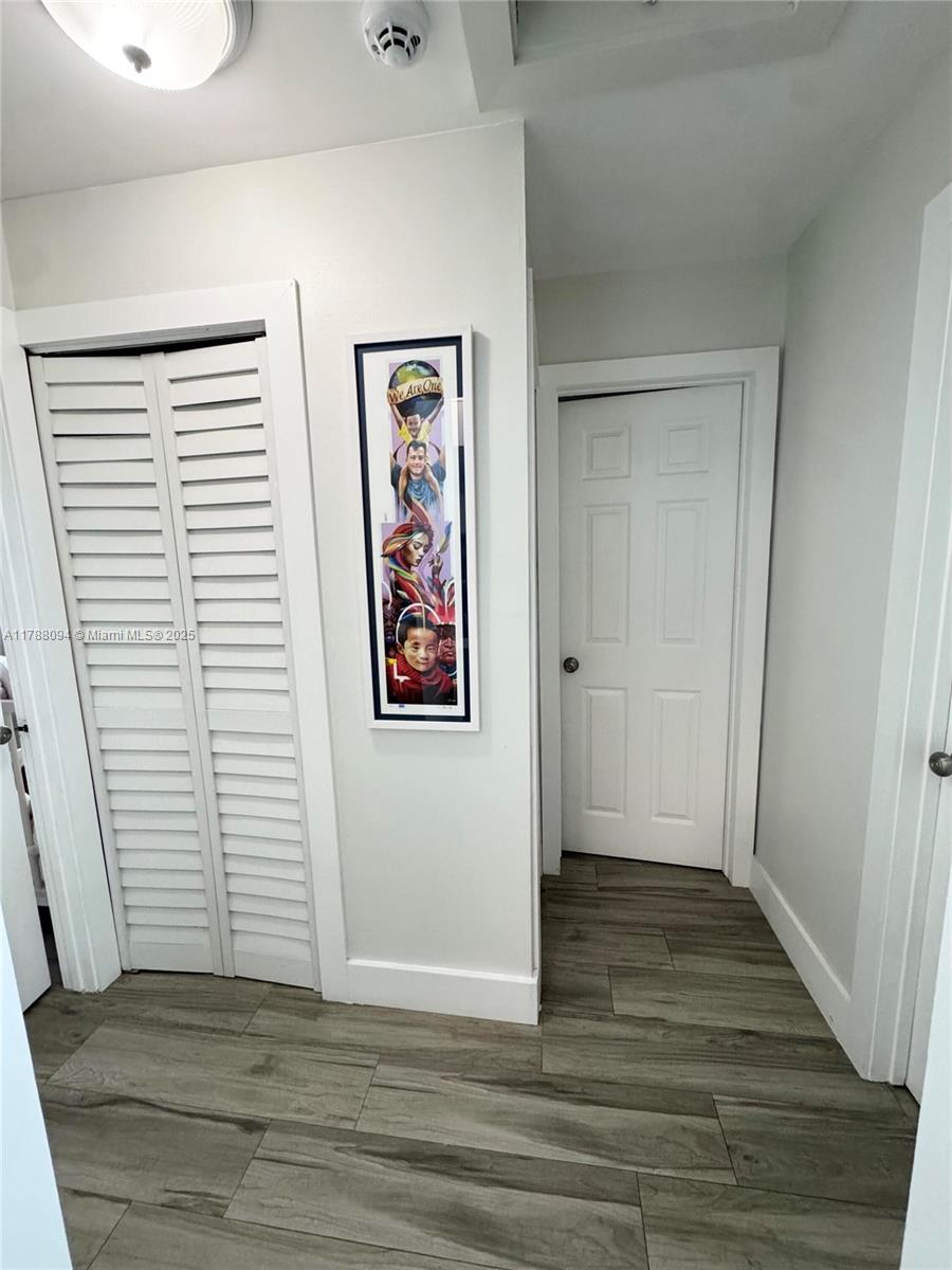 14626 Southwest 128th Court Road Miami, FL 33186 - Photo 6 of 41 a view of an empty room with wooden floor