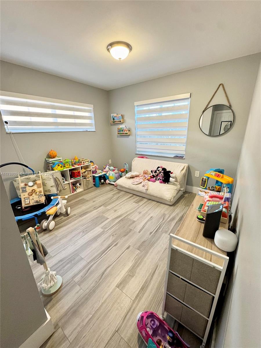 14626 Southwest 128th Court Road Miami, FL 33186 - Photo 7 of 41 a bedroom with a bed and wooden floor