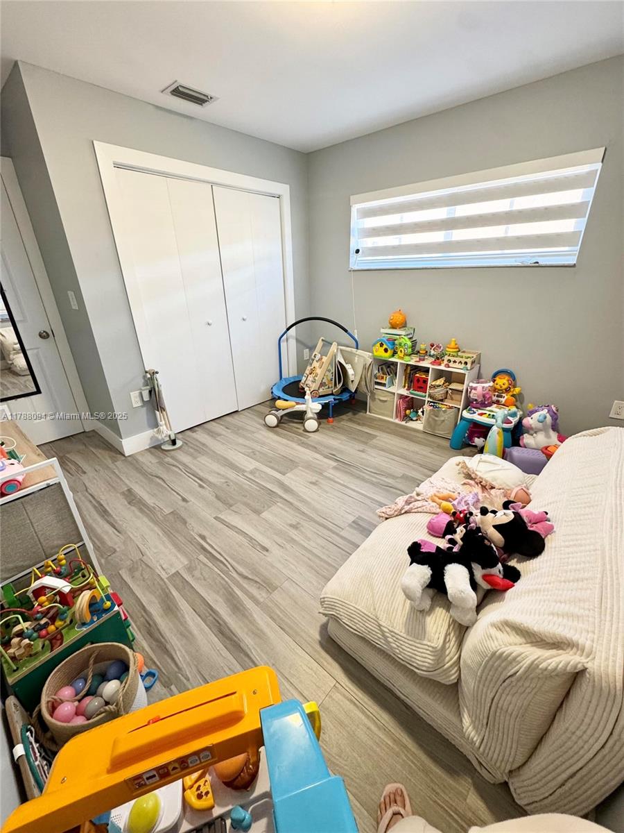 14626 Southwest 128th Court Road Miami, FL 33186 - Photo 8 of 41 a bed sitting in a bedroom next to a window