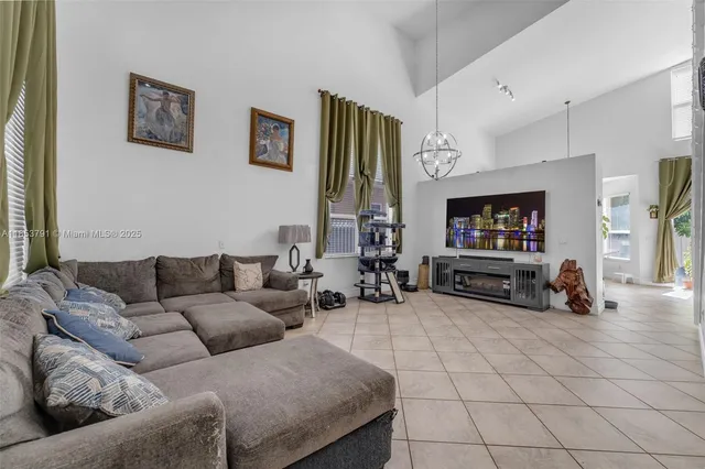 a dining room with furniture and floor to ceiling window