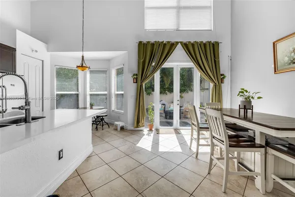 a kitchen with cabinets and chairs