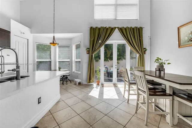 a kitchen with cabinets and chairs
