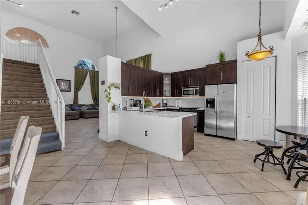 a kitchen with granite countertop a sink and cabinets