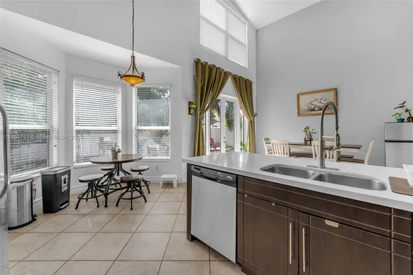 a backyard of a house with table and chairs