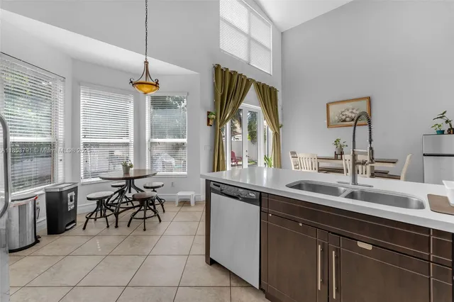 a backyard of a house with table and chairs