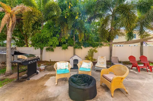 a view of a house with backyard and sitting area