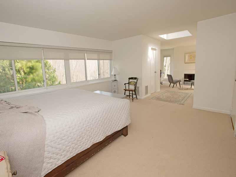 614 Hollow Tree Ridge Road Darien, CT 06820 - Photo 14 of 21 a bed room with a bed and a chair