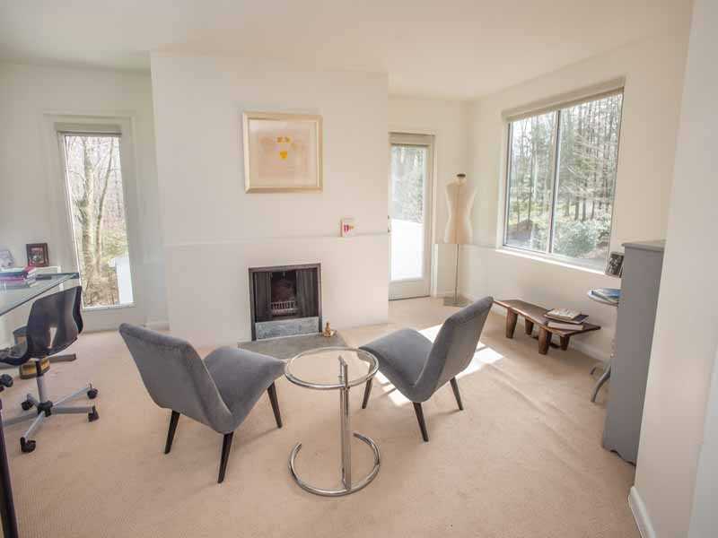 614 Hollow Tree Ridge Road Darien, CT 06820 - Photo 15 of 21 a living room with furniture and a fireplace