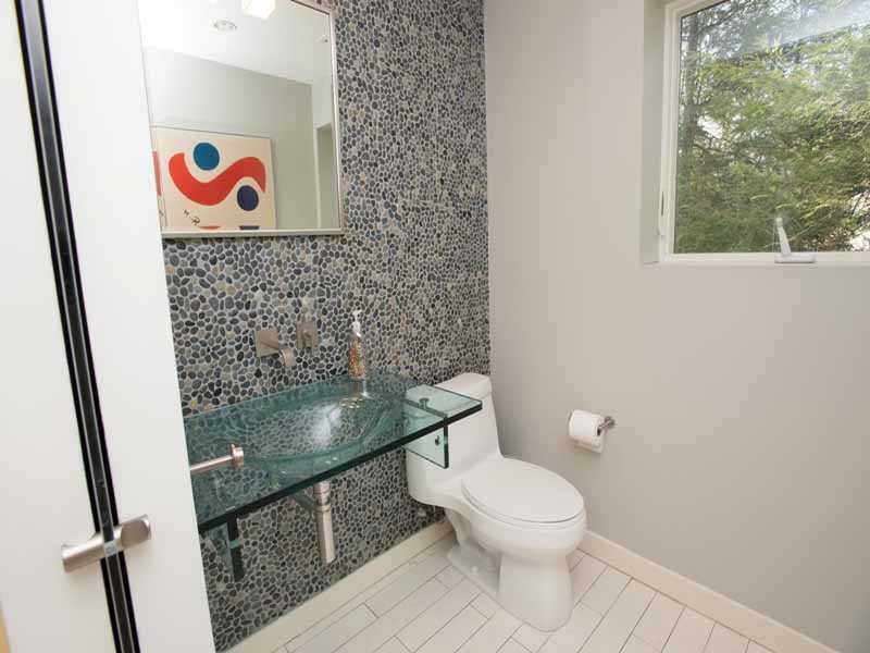 614 Hollow Tree Ridge Road Darien, CT 06820 - Photo 19 of 21 a bathroom with a toilet and a picture on the wall