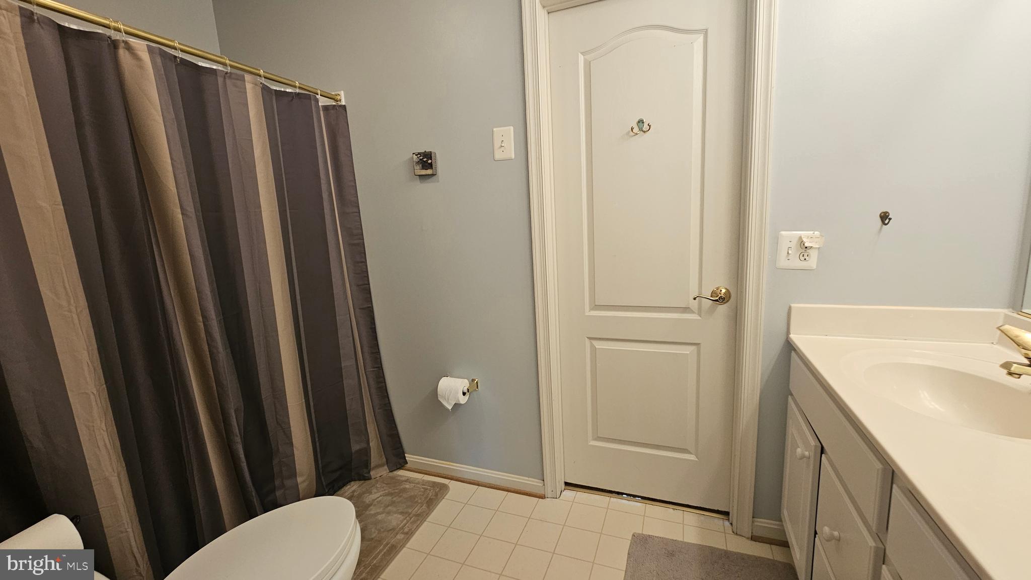 6107 Traceys Overlook Road Tracys Landing, MD 20779 - Photo 32 of 67 a bathroom with a sink a toilet a mirror and shower