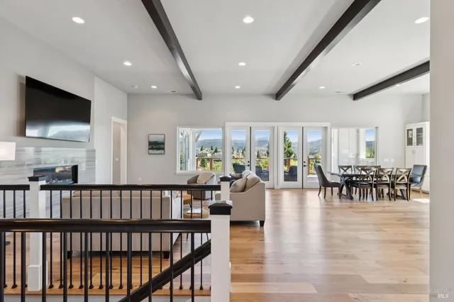 a living room with furniture and view of kitchen