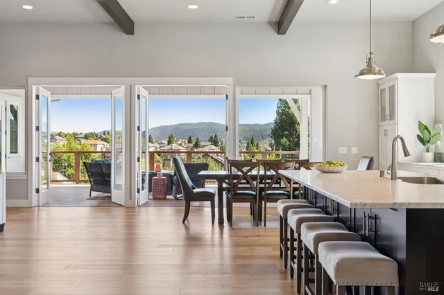 a living room with furniture and view of kitchen