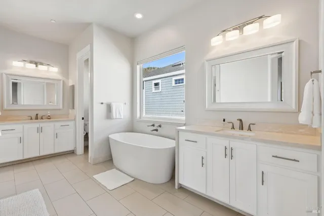 a spacious bedroom with a bed and large windows