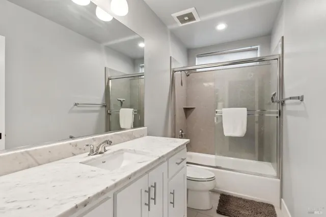 a kitchen with stainless steel appliances a sink a stove cabinets and a window