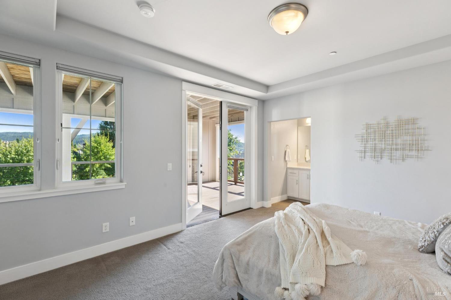 5980 Vista Ridge Santa Rosa, CA 95409 - Photo 47 of 63 a spacious bedroom with a bed and large windows