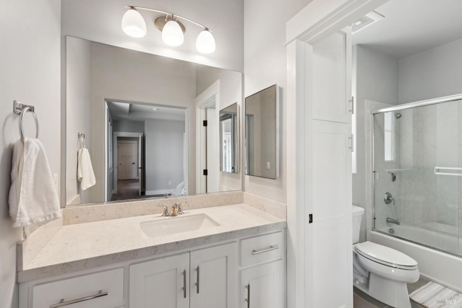 5980 Vista Ridge Santa Rosa, CA 95409 - Photo 49 of 63 a bathroom with a double vanity sink toilet mirror and shower