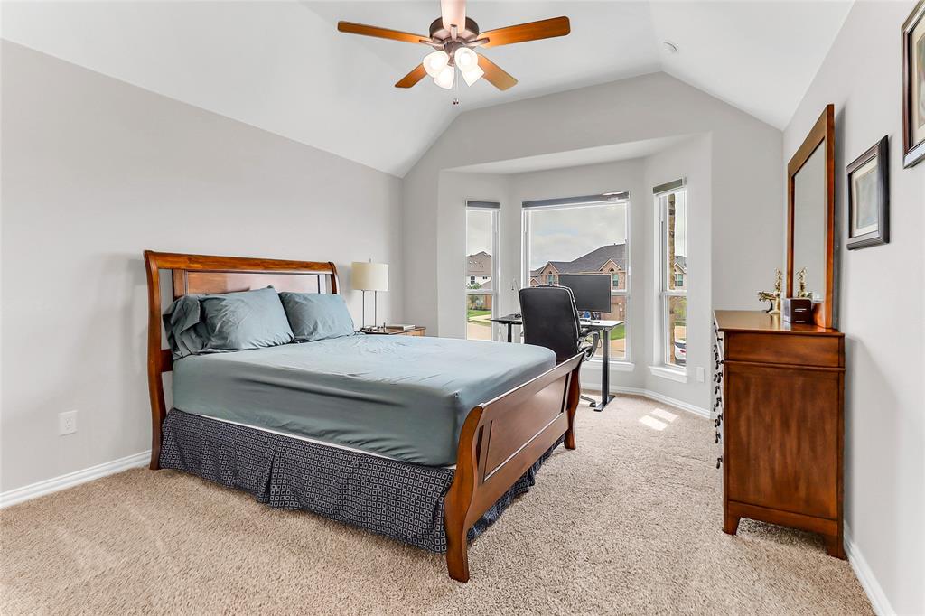 3425 Cotton Mill Road Celina, TX 75009 - Photo 22 of 40 a bedroom with a bed and wooden floor