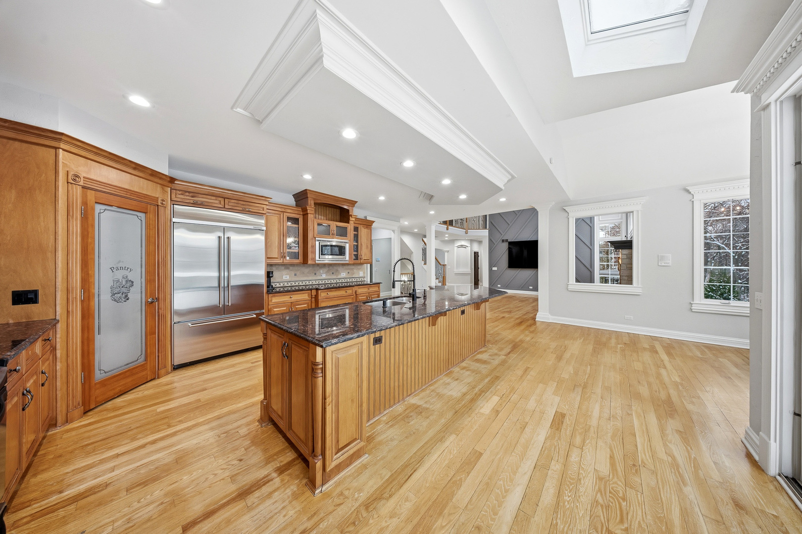 761 Reserve Court South Elgin, IL 60177 - Photo 17 of 89 a view of a living room kitchen with stainless steel appliances granite countertop a stove and a wooden floors
