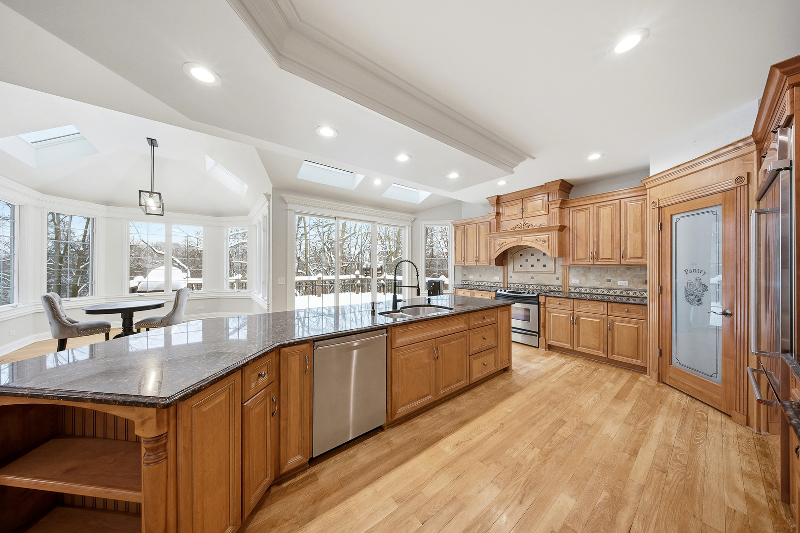 761 Reserve Court South Elgin, IL 60177 - Photo 20 of 89 a large kitchen with granite countertop lots of counter space wooden floor and stainless steel appliances